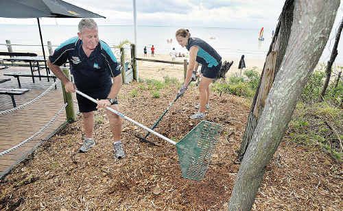 Larry Burch and Emma-Kate McGeorge rake mulch over a newly cleaned up area beside Aquavue Cafe at Torquay; and (right) what they started with. Larry Burch and Emma-Kate McGeorge rake mulch over a newly cleaned up area beside Aquavue Cafe at Torquay; and (right) what they started with.